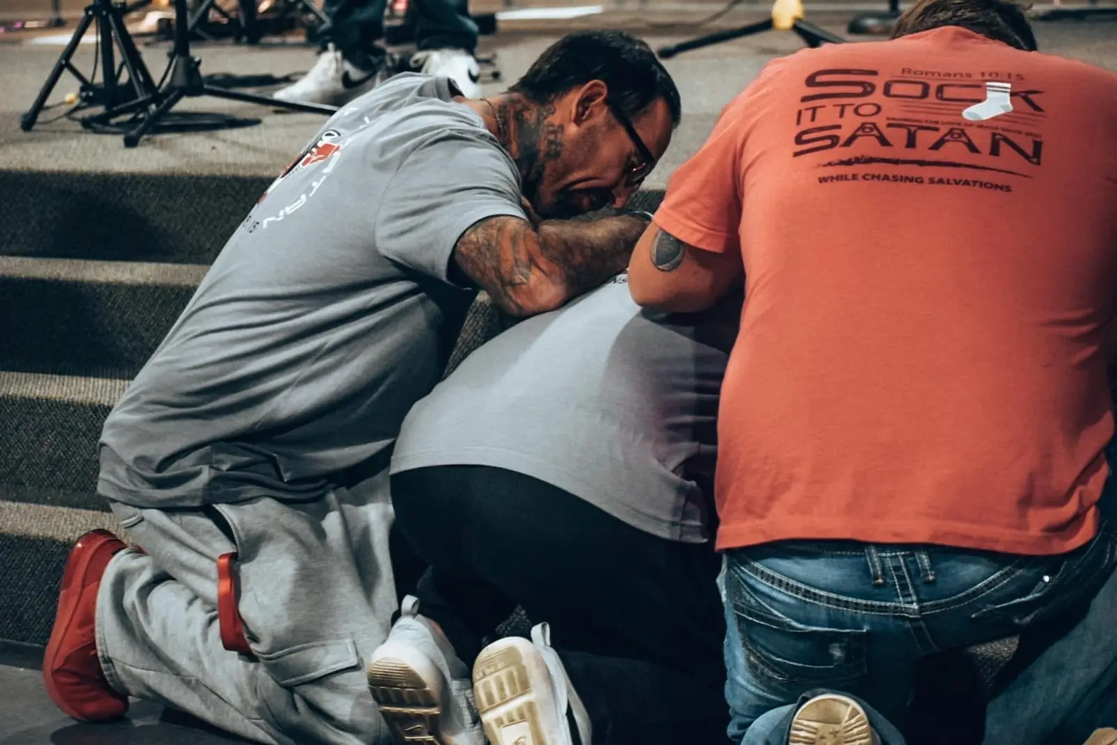 Men kneeling together in prayer