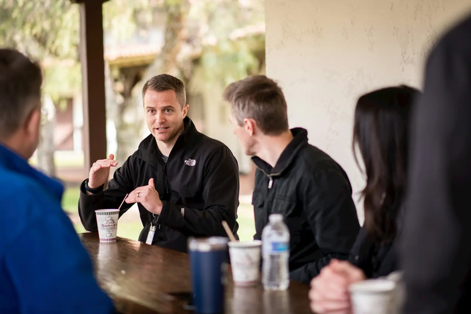 Men talking around a table during a discipleship meeting