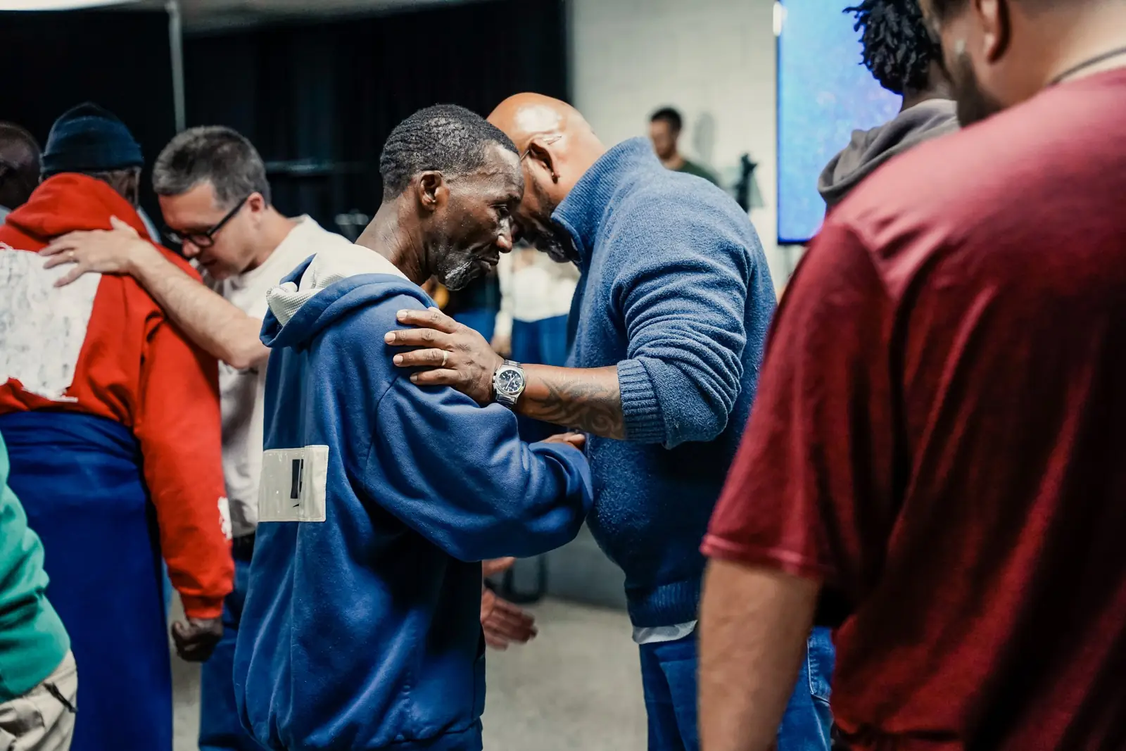 Two men embracing during a service