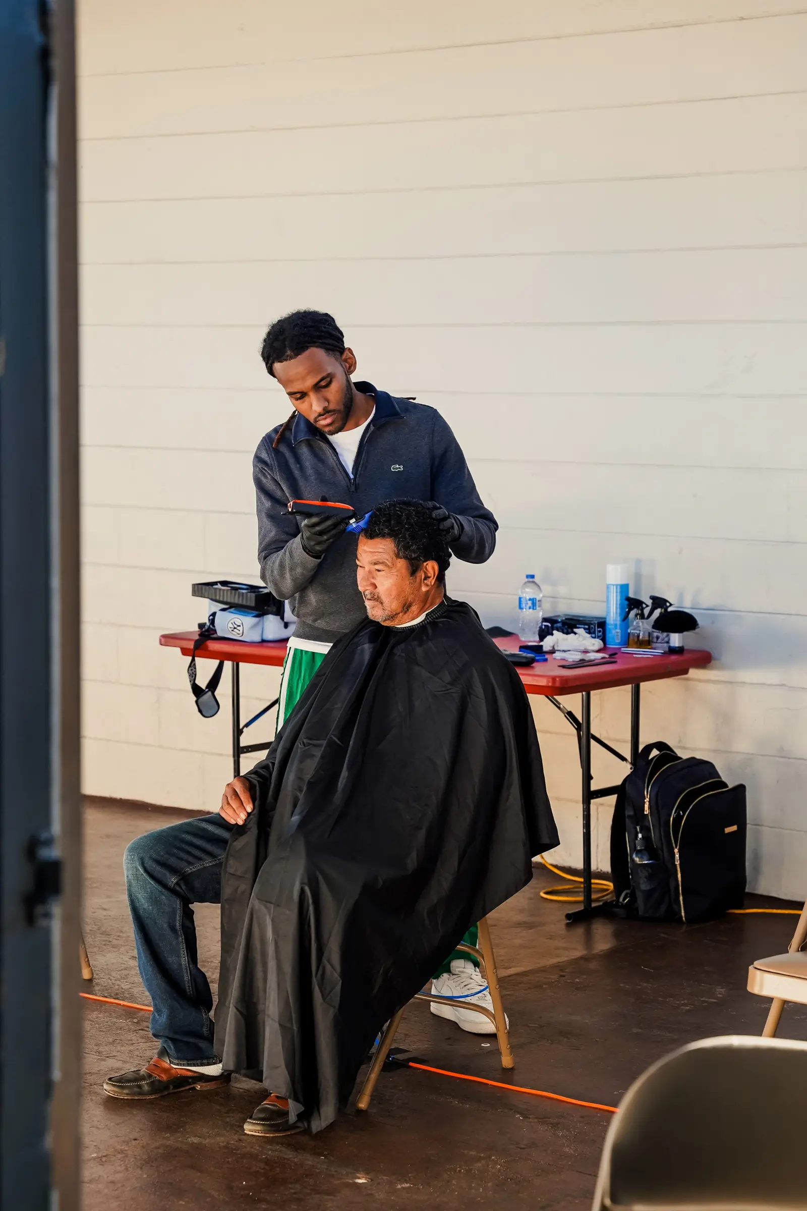 A volunteer giving a free haircut