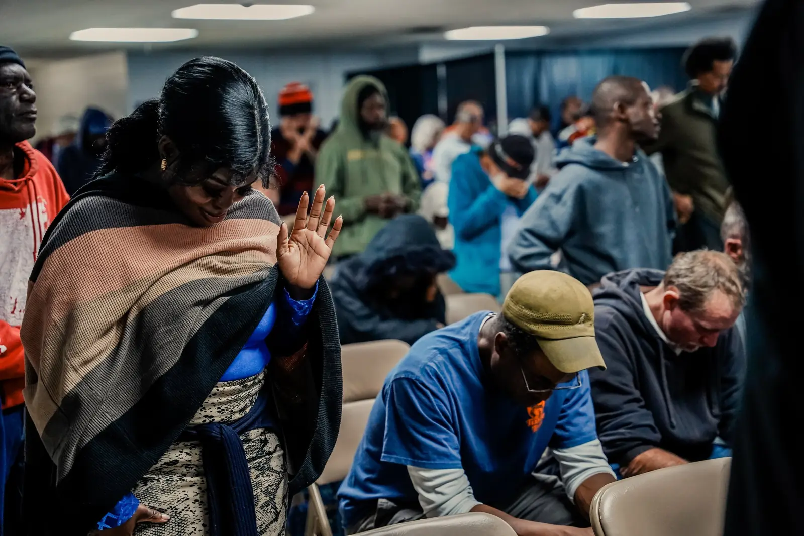 People with heads bowed in prayer