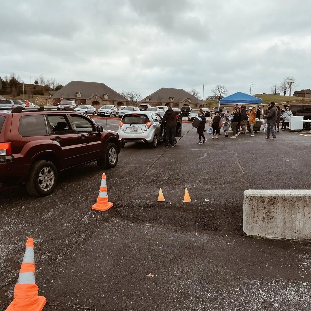 Volunteers and vans in the church parking lot before a Saturday outreach